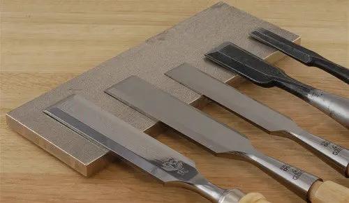 5 Chisels sharpened and on a metal block
