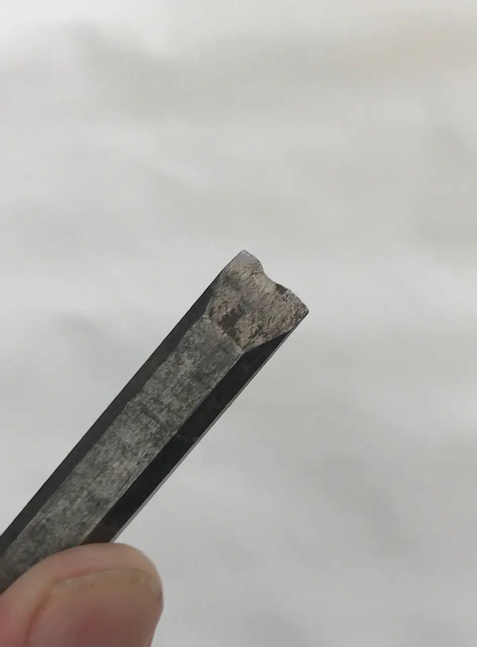 Close-up of a worn-out chisel on a white background
