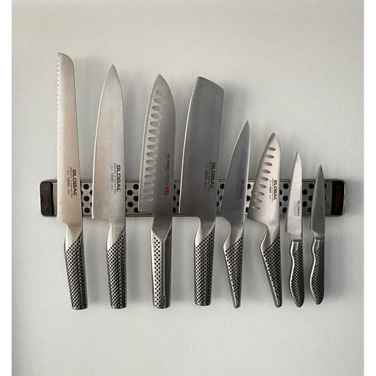 8 Steel global knives on a magnet rack stuck to a wall