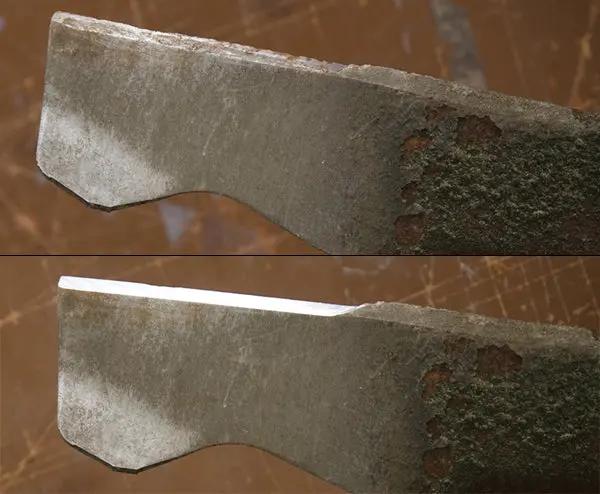 Close-up of a lawn mower blade with a brown background